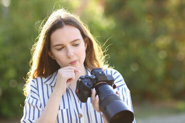 Doubtful photographer checking mirrorless camera