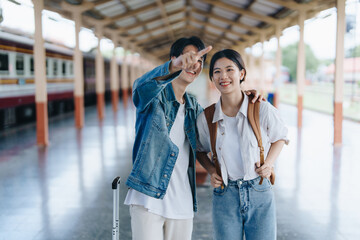 Tourist couples showing their love and happiness in a sweet way while waiting for their journey at the train station.