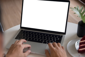 man using and typing on laptop computer mockup with blank screen.
