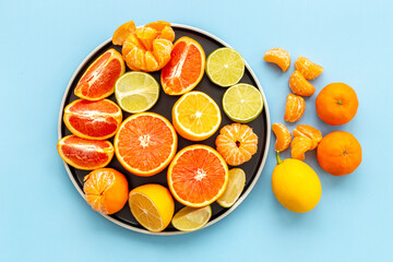 Plate of fresh citrus fruits slices oranges and grapefruits