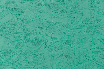 Aquamarine turquoise paint chipboard abstract pattern surface, pressed wood texture, particleboard background