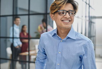 Close-up caucasian serious puzzled clever guy student in glasses looking at camera posing indoors