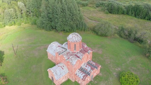 The old Orthodox Church of the Savior on Kovalev on the outskirts of Veliky Novgorod. The view from the drone on a sunny day.