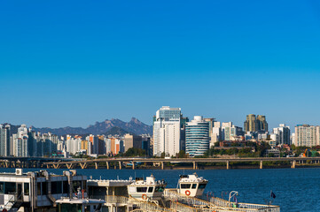 Seoul cityscapes, skyline, high rise office buildings and skyscrapers with blue sky and cloud in Seoul city, South Korea