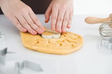 Obraz na płótnie Canvas Close up of woman using mold to make heart-shaped dough.