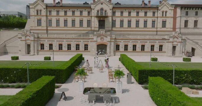 aerial view of the decorating team prepares the venue for the wedding party at mimi luxury castle