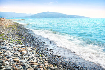 Emerald Black Sea and rocky shore, sun loungers and umbrellas, Aleksino, Krasnodar Territory, Novorossiysk