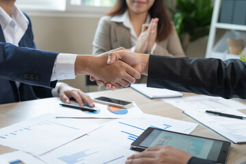 Executives are shaking hand after results success to target. financial data analysis and market growth report chart. Planning Strategies, startup project, profitable strategy, Business meeting time