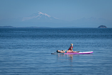 Woman and Dog Relaxing on Paddleboard