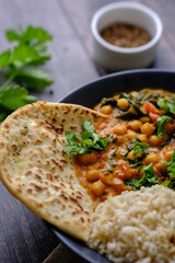 Vegan Chickpea curry on a dark background. Close-up. Healthy vegetarian food concept. Traditional Indian food concept.