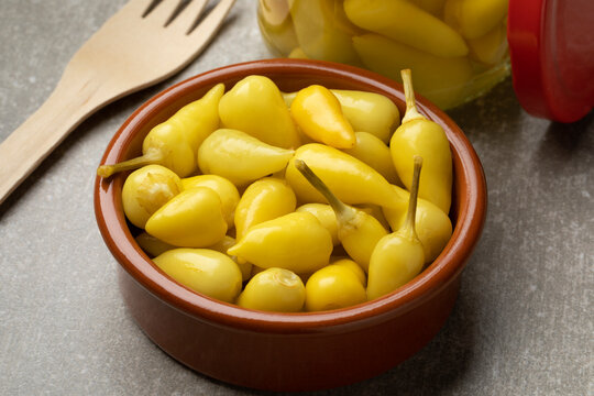 Bowl with small pickled yellow Turkish hot peppers, Biberiye Tursusu, close up   