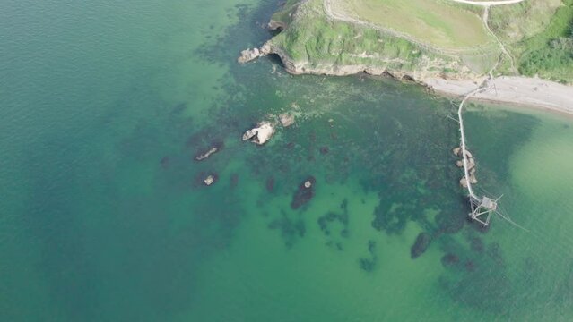 Impressive fishing platforms on stilts on the trabocchi coast of Abruzzo, Punta Aderci, Italy 4k drone