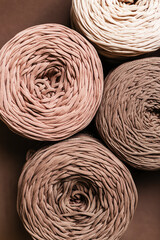 Knitted threads for knitting on a brown background top view