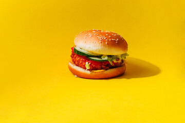 Banner burger with cutlet and vegetables on a yellow background. A creative concept of fast food and food delivery with space for text.