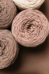 Knitted threads for knitting on a brown background.