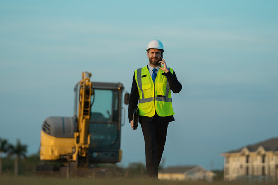 man of architect occupation speaking on phone outdoor. engineer man of architect occupation - Powered by Adobe