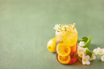 Lemon jasmine iced tea in a glass  on a green background