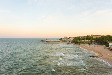 Fototapeta premium Aerial view of Sts. Constantine and Helena Resort beach with hotels at sunset golden hour. Black sea vacation in Varna. Travel to Bulgaria