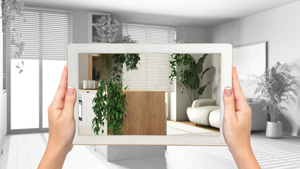 Augmented reality concept. Woman hands holding tablet with AR application used to simulate furniture and design products in total white background, kitchen and living room