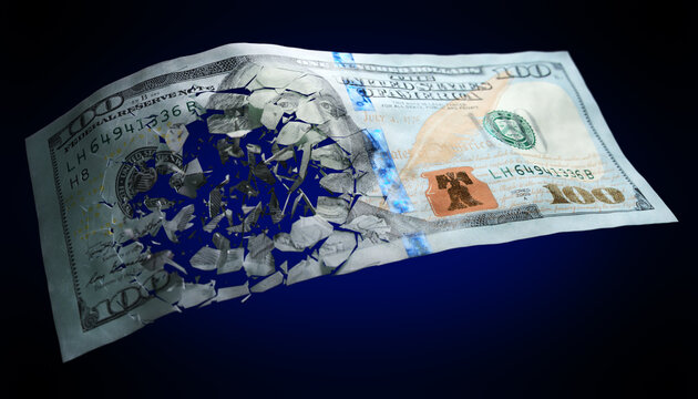 Broken US paper money on a blue background