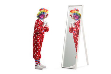 Full length shot of a clown putting on costume in front of a mirror