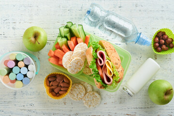Healthy food for school lunch concept. Healthy bread, meat sandwich with cheese, apple, fresh...