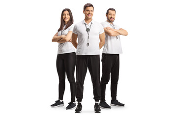 Fototapeta premium Full length portrait of male and female sport coaches with whistles posing