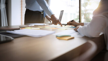 business people pointing on data paper on office table..