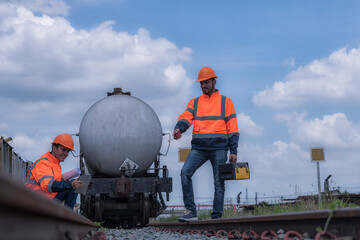 worker with helmet. worker with helmet. Two Engineer stand and sitting on railway inspection. construction worker on railways. Engineer work on Railway. Rail, engineer, Infrastructure.