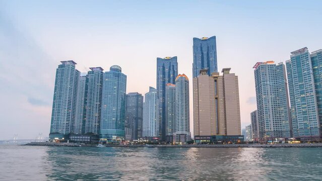 Busan South Korea time lapse 4K, city skyline day to night timelapse at Busan Marina