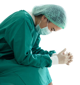 A distressed female doctor, filled with stress, fear, sadness, and tears, reflecting the aftermath of a failed or mistaken surgery operation. Isolated on a white background.