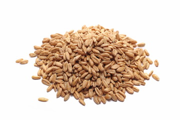 Organic peeled spelt grains pile isolated on white, side view