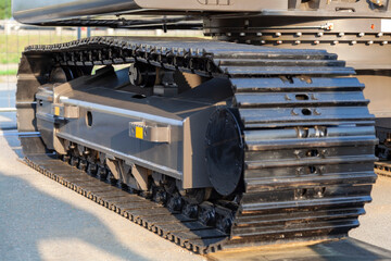 Black caterpillar of a mining excavator close-up