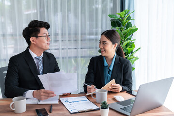 Busy analyst team in office discuss data analysis and marketing strategy using BI dashboard and statistics to improve business performance at corporate meeting with successful teamwork. Jubilant