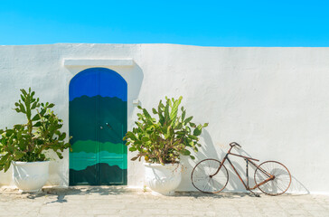The  Blue door with cactus and the traditional white walls in the town of Ostuni (Puglia - Italy).