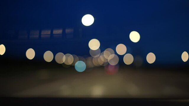 Blurred lights evening city traffic bokeh. Defocused night city traffic. Blurred lights bokeh car headlights driving evening city road. City night traffic background