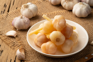 Fermented a garlic head,Pickled garlic in white plate