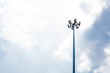 Flood light tower with sky in the background on a bright sunny day