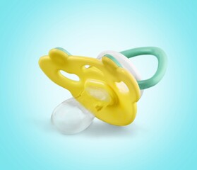 Orthodontic baby colored pacifier on background.
