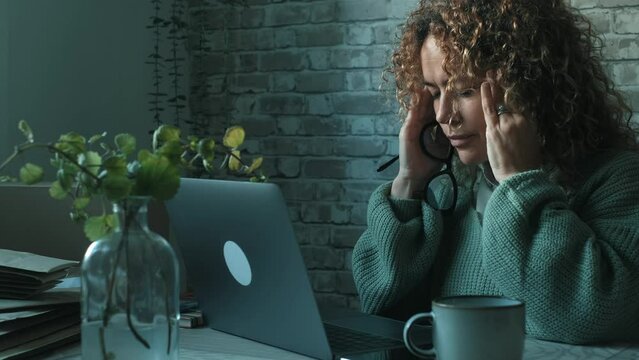 One woman alone having a break in job laptop leisure work for headache and touch her front with hands. Chronic migraine. Overwork on laptop looking monitor illness. Painful bad health condition lady