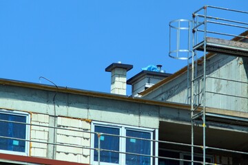 Under construction of a new building, view of the hollow brick chimney under construction (Chimney pipe on the roof sucking in fumes from the building's gas stoves )