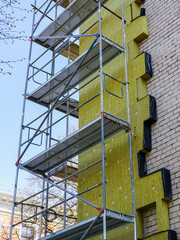 Thermal insulation of the facade of an apartment building with thick mineral rockwool slabs