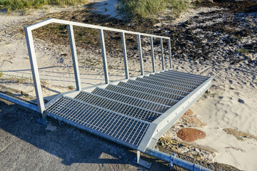 Public outdoor galvanized steel staircase with handrail for safety climbing on the embankment