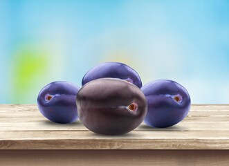 Fresh ripe tasty sweet plums on a background