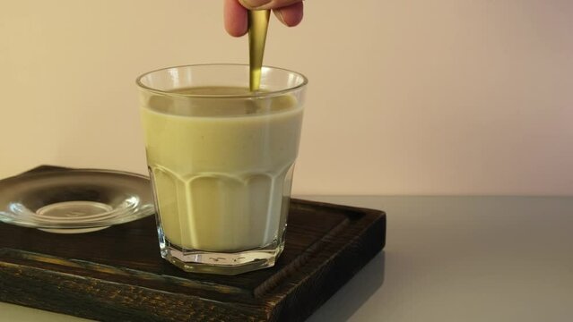Glass of Popular Indian drink Karak tea or Masala chai. Prepared with the addition of milk, variety of spices and spices.