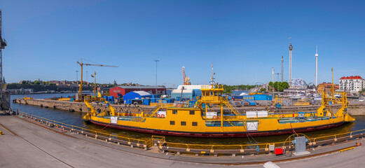 Yellow road ferry moored in a dry dock in the island Beckholmen, a sunny summer day in Stockholm