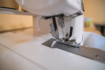 Close-up of the needle mechanism of a household electric sewing machine.