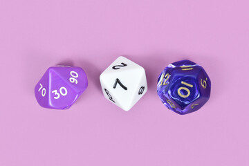 Three different roleplaying RPG dice on violet background
