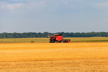 Combine harvester working on a wheat field. Harvesting the wheat. Agriculture concept