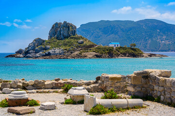 Ruins of the Basilica St. Stefanos in front of beautiful Island Kastri - beautiful coast scenery of Kos, Greece - 610404575